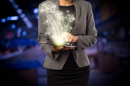 Business woman sending email by using digital tabletの写真素材