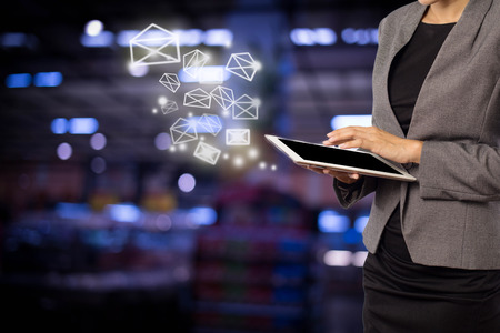 Business woman sending email by using digital tabletの写真素材