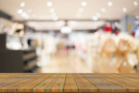 Empty wood table with blur supermarket background.