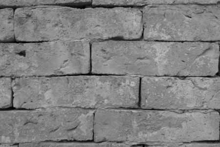 Old grunge brick wall background, while and black