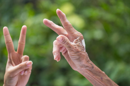 Old and young hands.の写真素材