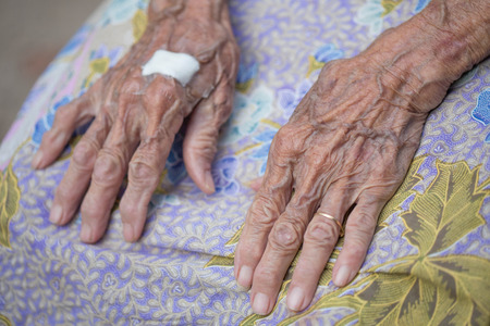Old and young holding hands.の写真素材