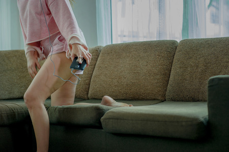 Young lady listening to the song live at home happily. In the pink dress he wore. And sofa at home