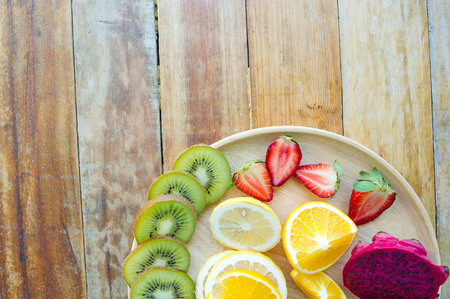 The fruits of health lover Healthy fruit And health care to eat healthy food. To the skin. The fruit is placed in a beautiful table, apple apricot, banana, orange, dragon, placed in the corner of the view.の写真素材