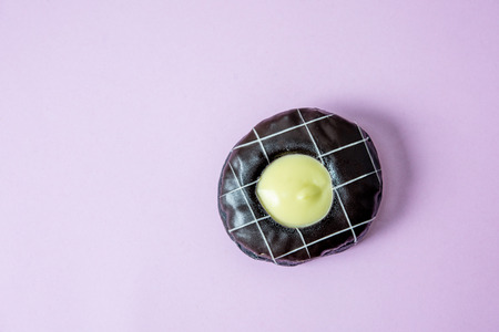 Donut chocolate Cover with chocolate and sprinkle with donuts. Lay on a pink background.