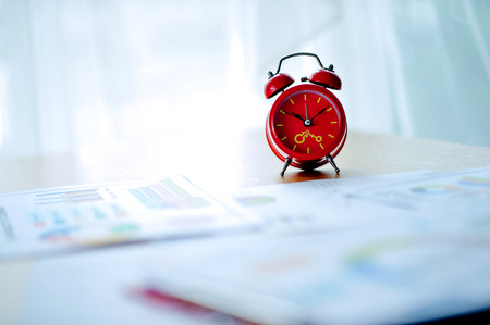 Old red alarm clock, red alarm clock Placed in the workspace. White room Beautiful colors.の写真素材