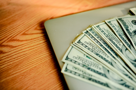 Business Savings, Property Stairs, or Mortgage Concepts: Home, Dollar, American Dollar, Notebooks, and Workstation Calculators. And the technology works online.の写真素材