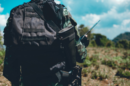 Soldiers are using the radio. And use the map For communication between military operations in the border forest. Guardianの写真素材