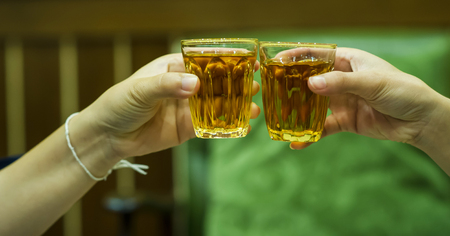 Hand and liquor juices in the liquor store drinking liquor. The concept of drinking and intoxicationの写真素材