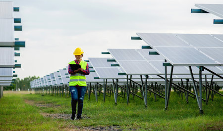 A young female solar cell engineer is working hard. Working in alternative energy Solar energy