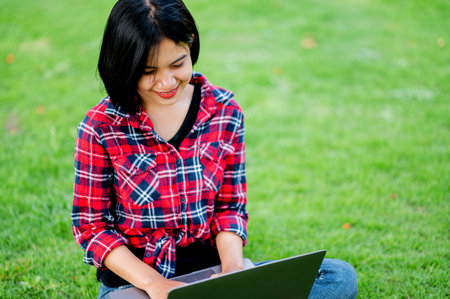 Asian women smile happily and laptop. Work online online communication Messaging Online learning...