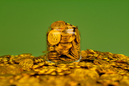 Saving gold. Saving money. Gold savings concept in a glass jar. Store gold in a glass jar.の写真素材