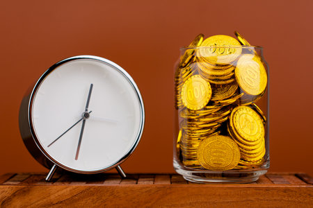 Gold Coins Save gold coins in glass jars. Concept of having money, having time and having a house
