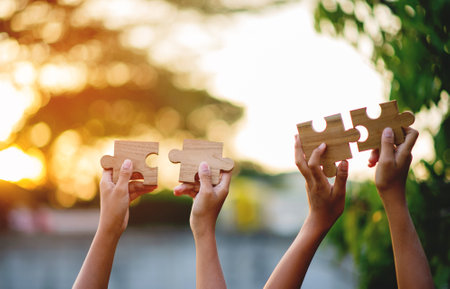 jigsaw and hands Combine the power of unity, teamwork, teamwork.の写真素材