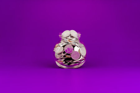 Savings in a glass bottle, savings, salary, income from work savings conceptの写真素材