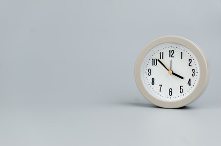 Alarm clock on gray scene, time concept operation of time When it's important to work and liveの写真素材