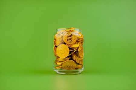 gold coins in a glass jar Gold savings concept. Lots of gold. Gold stocks.
