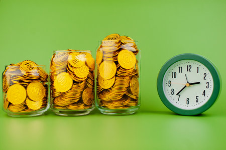 gold coins in a glass jar saving money coin coin bank income wages expenditure money financial...