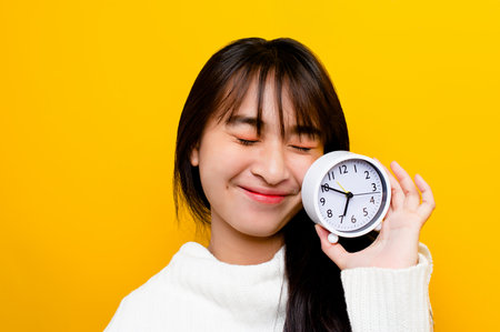 People and time. Girl and his white alarm clock. importance of time The value of time spent in life time concept and punctuality in workの写真素材