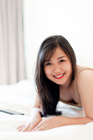 Wake up happy in the morning in bed Enough rest, full sleep, and a smile full of happiness. happy bedroomの写真素材