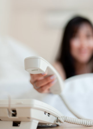 Phone in the morning, wake up, happy morning in bed Enough rest, full sleep, and a smile full of happiness. happy bedroomの写真素材