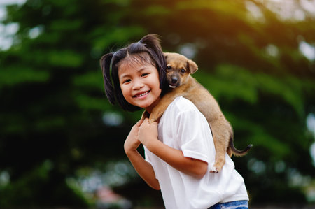 little girl and dog Love between man and dog Bonding of children and intelligent pets playing in the backyard love conceptの写真素材