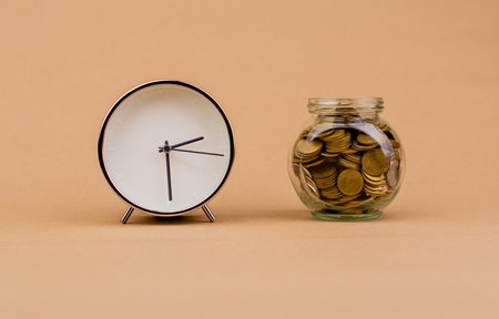 saving coin money in glass jar money and time investment dividend income salary cash flow finance and financial investment coin bankの写真素材