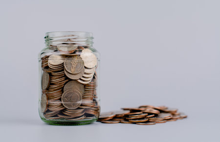Money coins. Saving coins in a glass jar. Coin bank, finance and financial investment Cash loans,...