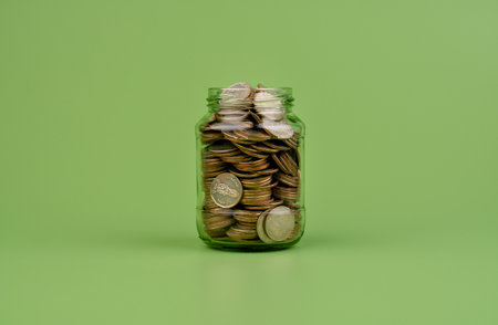 Saving coins in a glass jar Finance and Banking Coin Banks Income Wages Cash Flow Mutual Funds World Financial Marketsの写真素材