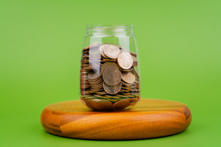 Money and time, savings, coins in a glass jar, financial planning financial investment Income, cash flow and living expensesの写真素材