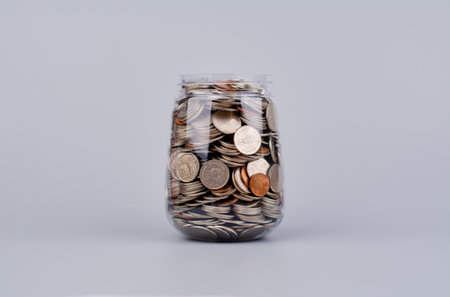 Money and time savings in a glass bottle, financial planning and investing in the stock market.