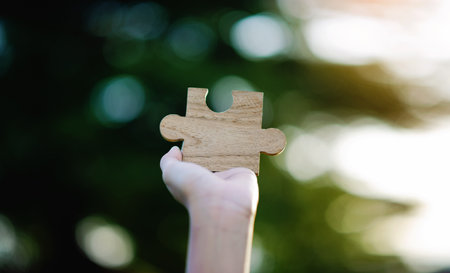 Wooden jigsaw puzzle, cooperation and teamwork, unity among groups and inspiration for good work.の写真素材