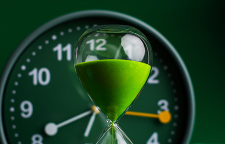 Hourglass stops time of work and life. Process and rules of limited time. Hourglass photo in studio.の写真素材