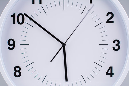 Clock tells the time of work and life. Time photography in studio. Concept of time and punctuality.の写真素材