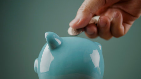 Saving coins in a piggy bank, good savings planning and financial stability, financial success goals.の写真素材