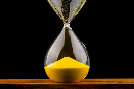 Yellow hourglass concept of working with limited time and quality time management