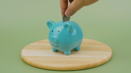 Saving coins in a piggy bank, good savings planning and financial stability, financial success...