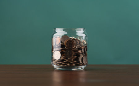 Saving coins in a piggy bank, building good financial discipline, financial planning and investing for the future.の写真素材
