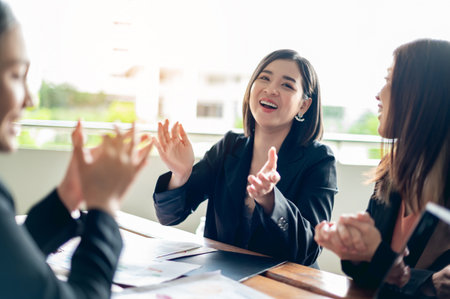 Meeting and teamwork, congratulations to young businesswomen, goals for growth in corporate business and success in work.の写真素材