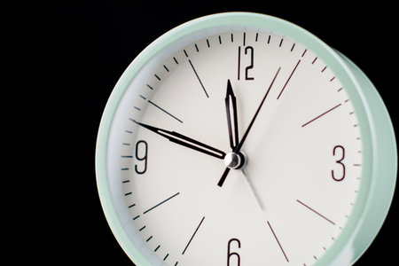 Clock tells the time of work and life. Concept of time and quality time management. High quality studio photography.の写真素材