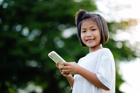 Social media communication for Asian girls who are enjoying exploring the world of technology on their own.の写真素材