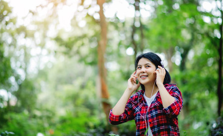 Listening to music with headphones and enjoying nature and relaxing with myself.の写真素材