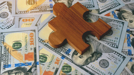 Paper currency dollars and jigsaw puzzles, finance and financial planning, financial investments, income from working to earn money.の写真素材