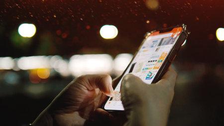 Using smartphones for online communication and social media, online shopping, and conducting financial transactions through modern networks.の写真素材