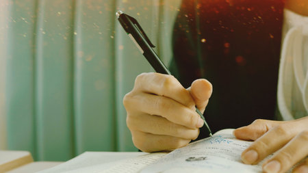 Writing activities involving note-taking using pen and paper, learning and storytelling, freelance writing, and office paperwork.の写真素材