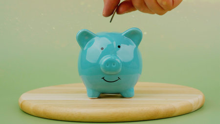 Saving coins in a piggy bank, good financial planning, financial growth goals, and financial success.の写真素材