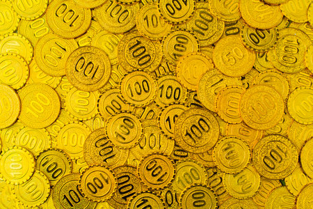 Numerous gold coins and photographs showcase luxury and investment in the high-value gold market, representing financial stability and investment opportunities.の写真素材