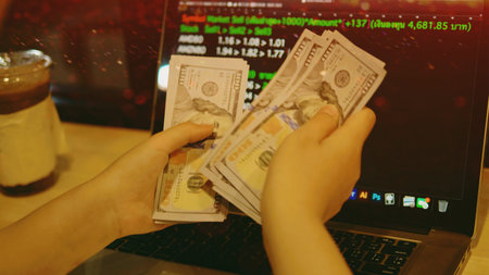 Counting dollars, earning income from work, and financial planning and investment.の写真素材