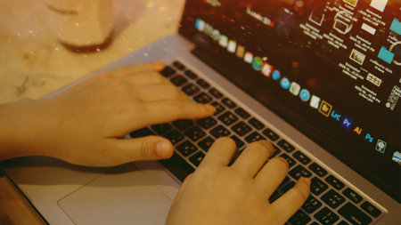 Working on a laptop for sending emails and writing, engaging in freelance writing activities, and earning money.の写真素材