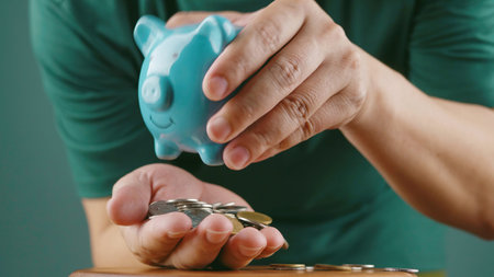 Saving coins in a piggy bank, financial planning, and investing for the future for financial growth.の写真素材